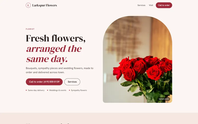 The first screen of the Larkspur Flowers sample site: Fresh flowers, arranged the same day, beside a vase of red roses.